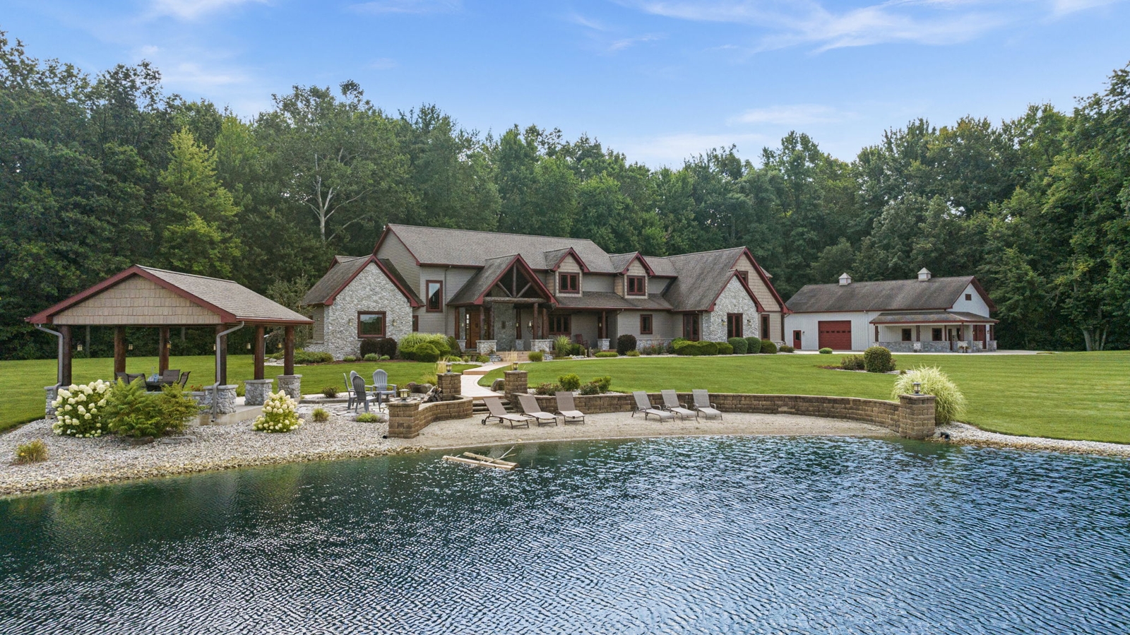 Grayish house with a pond and beach